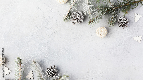 Christmas composition. Christmas fir tree branches, gifts, pine cones on wooden white rustic background. Flat lay, top view. Copy space. Banner backdrop