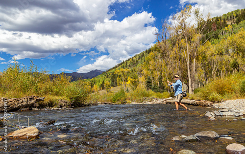Fly Fisherman in action on Rocky Mountain stream Near Telluride, CO.