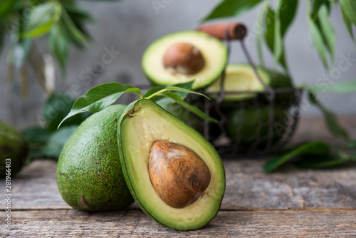 Fresh green avocado on wooden background. Selective focus. Horizontal orientation.