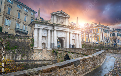 Bridge and the gate Porta San Giacomo on the Venetian Walls (Mure Venete) in the Upper Town (Citta Alta) in the old city of Bergamo, Italy at sunset