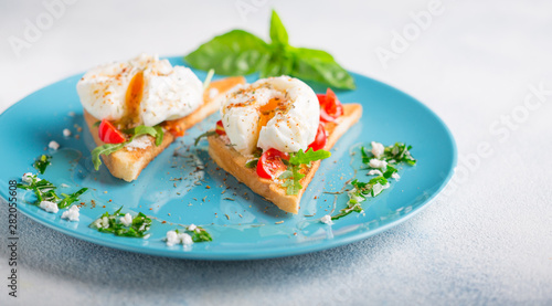 Poached eggs and toasted toast on a blue plate