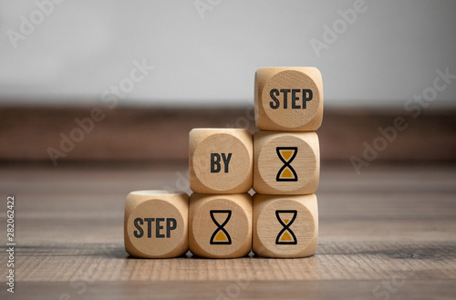 Cubes and dice with step by step on wooden background