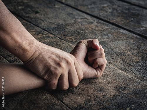 Hands for rape and sexual abuse concept.Sexual abuse is a problem or Social issues concept. Man's hand holding a woman hand for rape and sexual abuse.