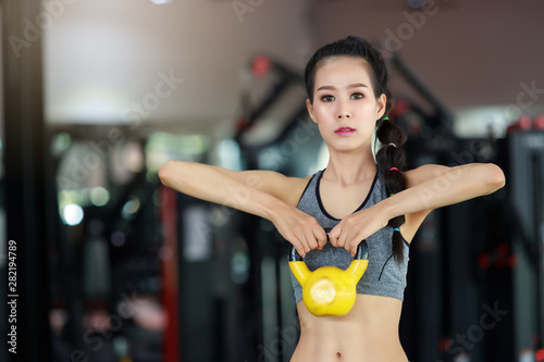 Fitness woman exercise with Kettlebell in gym