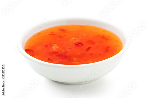 Sweet chilli sauce in a white ceramic bowl isolated on white.