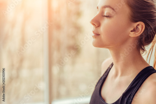 Young woman doing breathing exercise