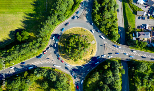 Composite aerial image of traffic using a small roundabout with multiple connecting roads