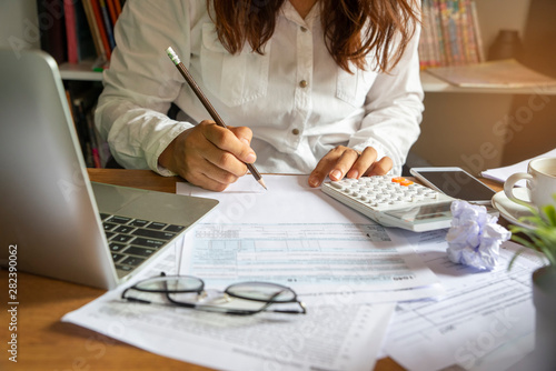 Budget planning concept, Accountant is calculating company's annual tax. Calendar 2024 and personal income tax forms for those who have income under US law placed on office desk