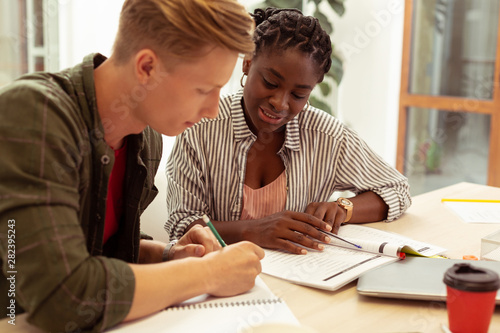 Cheerful international tutor consulting her new student