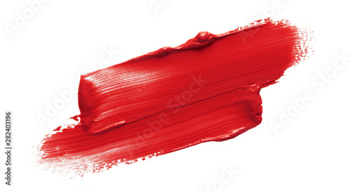 Lipstick smear smudge swatch isolated on white background. Cream makeup texture. Bright red color cosmetic product brush stroke swipe sample