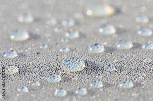 Background design made of water drops on a gray background