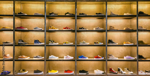 Lots of different sneakers on the showcase on market. Image of sport shoes on shop-window