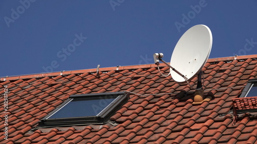 Satellite dish on red roof