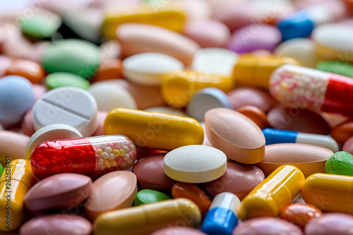 Close up of variety of colorful pills, capsules, and tablets