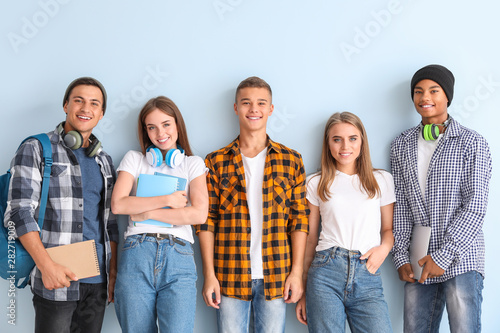 Portrait of young students on color background