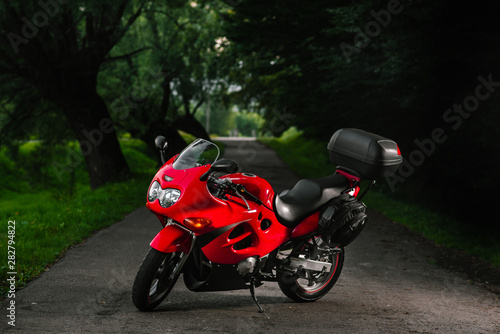 Cool red sports bike outdoors in the evening