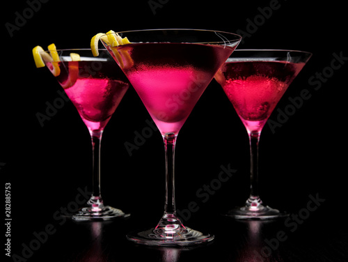 Closeup three cosmopolitan cocktails on black board