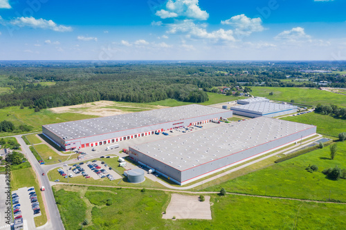 Aerial view of goods warehouse. Logistics center in industrial city zone from drone view. Background texture concept.