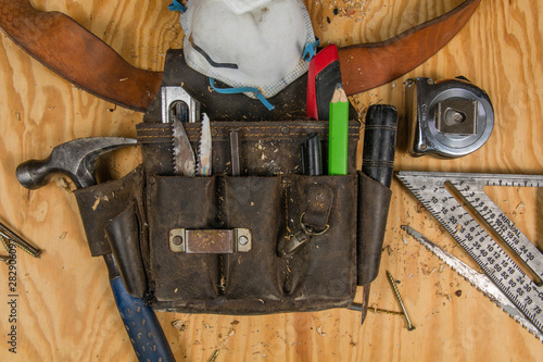 Carpentry tools on a wooden background at jobsite. construction, carpentry, tools toolbelt 