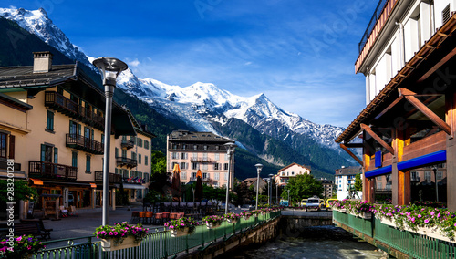 Breathtaking scenery of the Alps from Chamonix France. Chamonix downtown in summer. Beautiful buildings on a sunny day of summer. River, flowers, colorful facades.