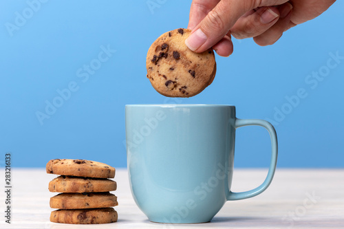 Dunking a biscuit into a cup of tea