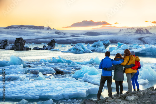 Group of tourist looking Beautifull landscape with floating icebergs in Jokulsarlon glacier lagoon at sunset