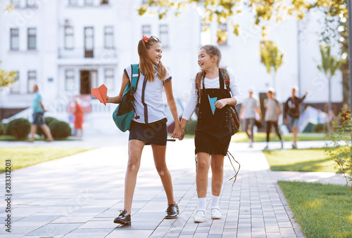 girls schoolgirls girlfriends walk walks near school in the park
