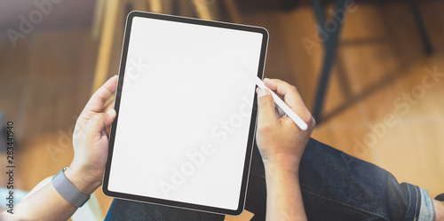 Professional freelancer editing his concept with blank screen tablet