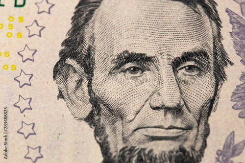 Abraham Linkoln portrait. 5 US dollars banknote closeup macro.