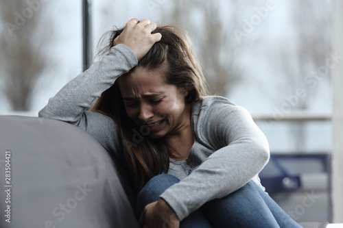Sad girl complaining and crying at home