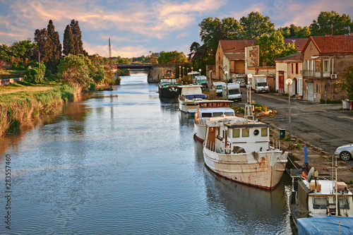 Saint-Gilles, Gard, Occitanie, France: waterway with boats in the town at the edge of the Camargue