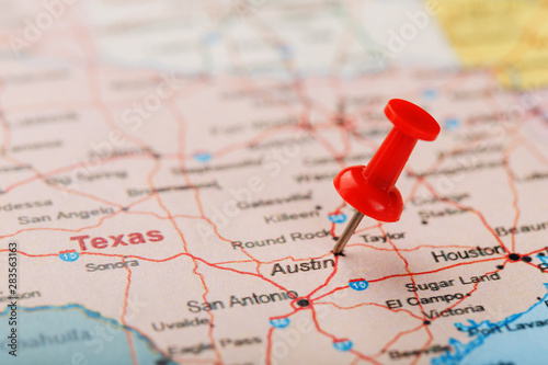 Red clerical needle on a map of USA, Texas and the capital Austin. Closeup Map Texas with Red Tack