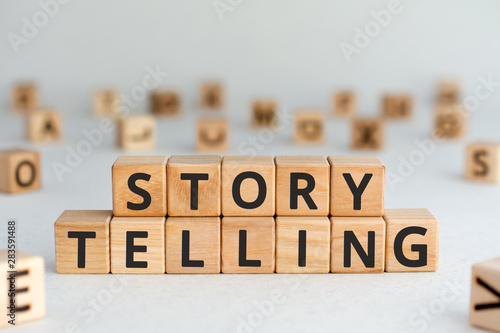 story telling - words from wooden blocks with letters, the art of telling stories storytelling concept, random letters around, white background