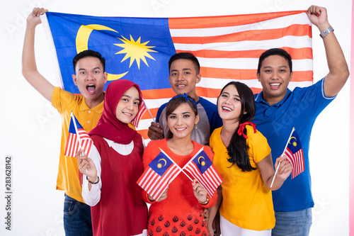 malaysia people holding flag celebrating independence day together