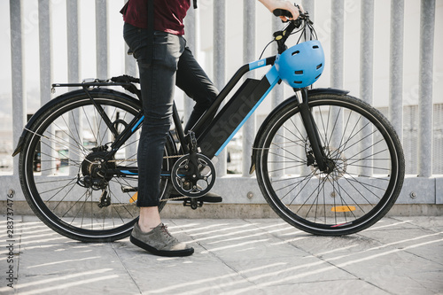 Urban cyclist taking a brake on e-bike