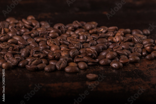 Coffee beans on stone background. Top view with copy space for your text. Roasted coffee beans background. Beans texture, macro