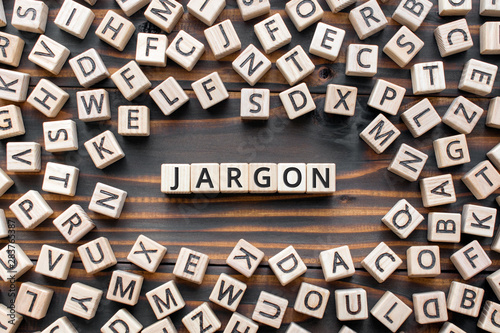 Jargon - word from wooden blocks with letters, special words and phrases jargon concept, random letters around, top view on wooden background