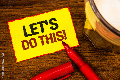 Writing note showing Let Us Do This Motivational Call. Business photo showcasing Encourage to start something Inspirational Words yellow paper note red border open marker cap coffee glass desk