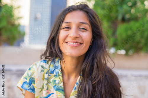 Young indian woman laughing in the street