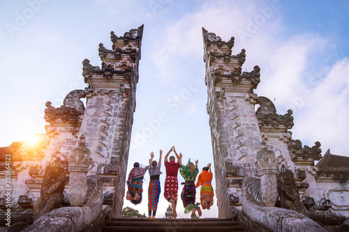 traveler jumping with energy and vitality in the gate of a temple