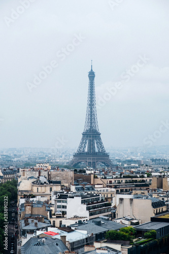 Beautiful view of Paris in a foggy day. Eiffel Tower and rooftops