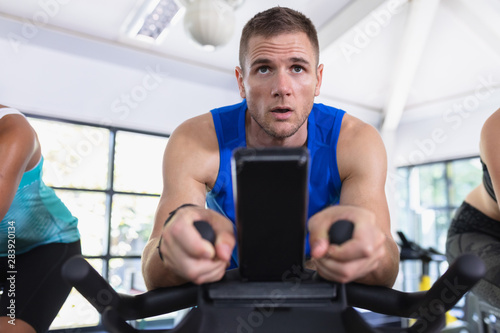 Fit man exercising on exercise bike in fitness center