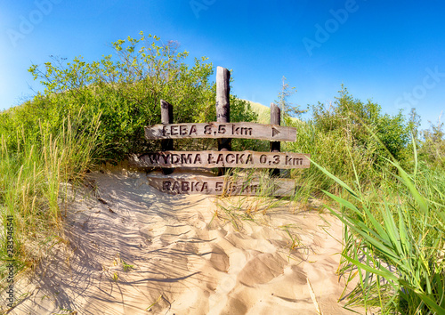 LEBA, POLAND - JULY 25, 2019: Slowinski National Park is situated on the Baltic Sea coast, near Leba, Poland. Desert landscape with the largest moving sand dunes in Europe. Hot day with clear sky.