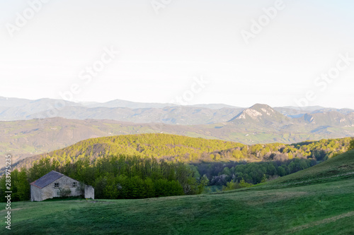 Apennines mountain landscape seen from the "Piana degli Ossi" at sunrise time in the morning, a wide valley near Firenzuola, on the path of the Gods road or "la via degli Dei", in Italy