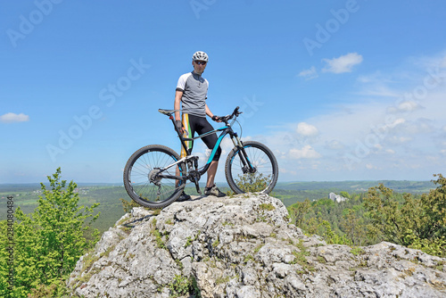 Zborów Mountain, Poland. Man on top of a mountain on a bike.