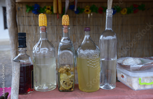 Bottles with traditional Ukrainian drink “samogon” sealed in traditional way and placed on a table