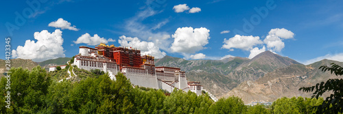 LHASA, TIBET / CHINA - July 31, 2017: Panorama of Potala Palace - home of the Dalai Lama and Unesco World Heritage. Blue sky, clouds. Amazing view of the ancient fortress. Center of Tibetan Buddhism.