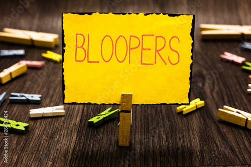 Handwriting text Bloopers. Concept meaning Embarrassing errors Mistakes Fails Missteps Problems Failures Clothespin holding yellow paper note several clothespins wooden floor