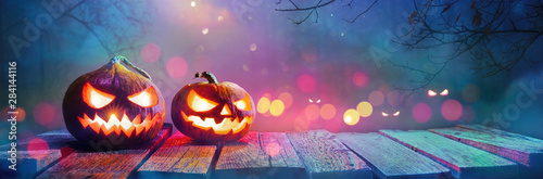 Jack O' Lanterns Glowing In Fantasy Night. Halloween Background