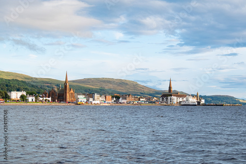 Scottish Town of largs Looking Across the Bay to the Town before sunset as the as the sun relects on the sky and the town.